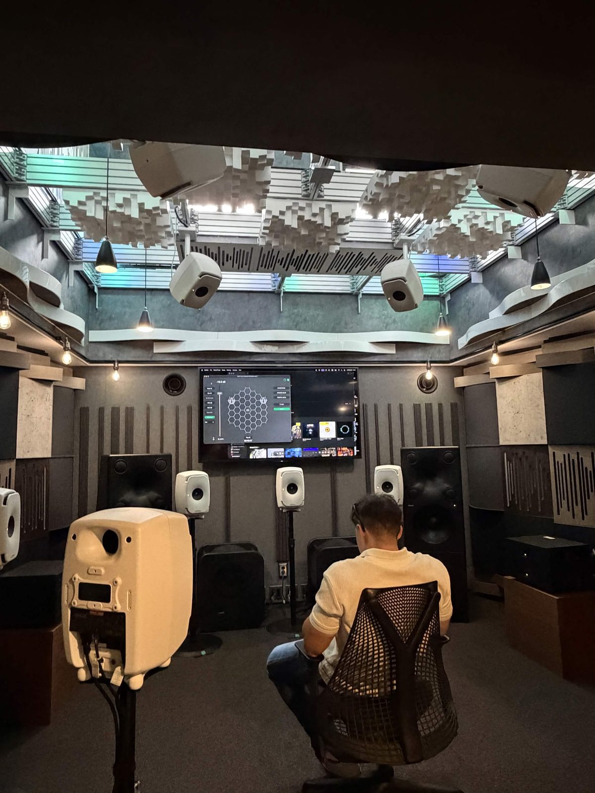 Immersive mixing room in Tokyo, ceiling covered with diffusers and suspended speakers